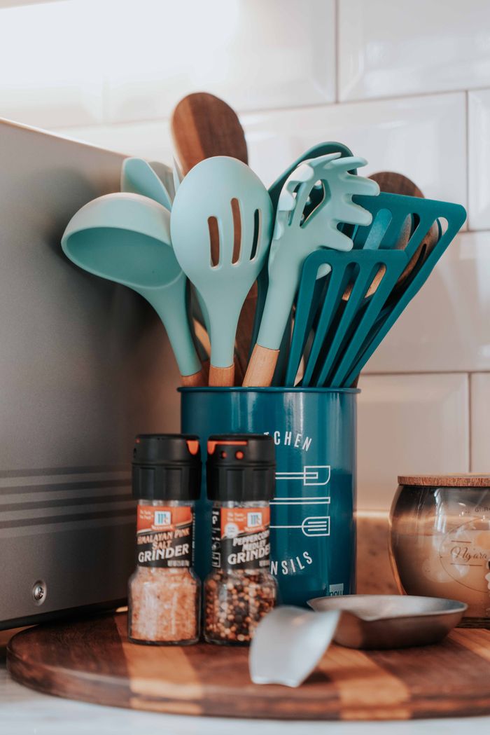 our-story Aesthetic kitchen utensils and spices setup on a wooden board for modern decor.